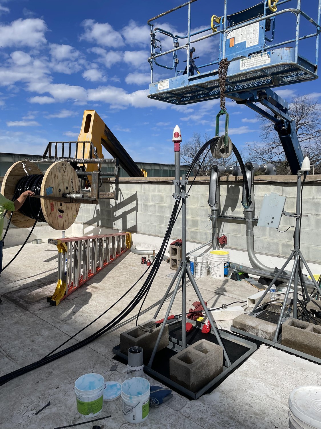 Astral Electric commercial electrical job site in Austin TX with boom lift and heavy cable pulling